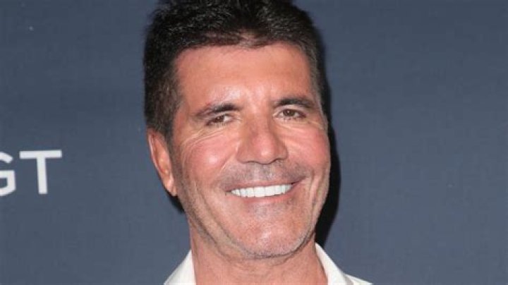 Simon Cowell breaks his back