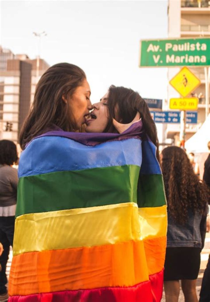 Two Women Kissing While Wrapped in Rainbow Flag &middot; Free Stock Photo
